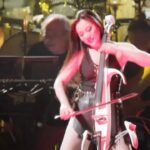 Hans Zimmer Instagram - I know you all love our @HansZimmerLive shows, but have you ever met the band members?! We are a wacky and crazy bunch and it was about time to introduce everyone! For the first #HansZimmerLive Meet the Band... it's the iconic Ms. @TinaGuo! Born in China to classical musicians, Tina fell in love with heavy metal and bought an electric cello to weaponize the sounds of an electric guitar. She struggled for years and did odd jobs like doing infomercials, playing the cello at funerals and even considered training to become a dominatrix. As a last-ditch effort to become a genre-fluid cellist, she recorded a metal version of "Flight of the Bumblebee" that went viral, and that music video inspired me to hire her for the #SherlockHolmes movie and eventually #WonderWoman. She puts on one hell of a live show, too!