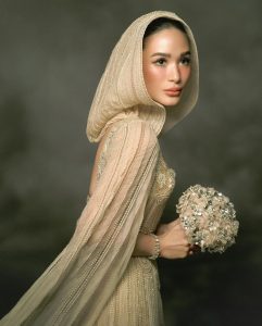 Heart Evangelista Instagram - Here comes the bride! @iamhearte is dressed in custom @eliesaabworld couture for a vow renewal ceremony with husband @escuderochiz this evening! 👰🏻‍♀️ The woman of the hour walked down the aisle at Balesin Island Club’s Royal Villa in a beige gown that features intricate beading and a veil—a personal request from Heart Evangelista, herself. “Elie Saab has a special place in my heart—it was actually one of the first shows I ever attended in fashion week. I’ve always loved their dreamy and romantic creations, and when I saw the custom couture dress, I knew that was it,” said Evangelista on why she chose the couturier to mark this special occasion and her ninth wedding anniversary. Evangelista also adorned a meaningful bespoke necklace with diamonds that she had collected over the years, some of which were gifted by her parents and her husband. Keep swiping to catch all the details of Evangelista’s glorious wedding ensemble up close then click the link in bio for the full story! 💍 Photography by: @bjpascual . . . #harpersbazaarsg #HeartEvangelista #ChizHeartChapterTwo #HeartEvangelistaWedding #ElieSaab #ElieSaabCouture #WeddingGown #Celebrityweddings #weddings2024 #BalesinIslandClub #Philippines