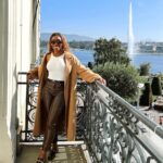 Jackie Aina Instagram - life is great 🥂 headband: amazon tank top: amazon coat: zara pants: Simkhai loafers: Chanel handbag: Bottega Veneta belt: Fendi Beau-Rivage Geneva