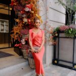 Jackie Aina Instagram - let me wear burnt orange ONE TIME 🤭 slip dress + cardigan: All Saints shoes + handbag: Chanel One Aldwych
