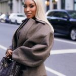 Jackie Aina Instagram - I’m not like other girls, I’m way worse 😘 coat + shorts @jacquemus via @farfetch boots @ralphlauren bag #bottegaveneta photos @nishajohny hair @kendrasboutique