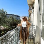 Jackie Aina Instagram - life is great 🥂 headband: amazon tank top: amazon coat: zara pants: Simkhai loafers: Chanel handbag: Bottega Veneta belt: Fendi Beau-Rivage Geneva