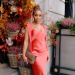 Jackie Aina Instagram - let me wear burnt orange ONE TIME 🤭 slip dress + cardigan: All Saints shoes + handbag: Chanel One Aldwych