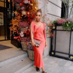 Jackie Aina Instagram - let me wear burnt orange ONE TIME 🤭 slip dress + cardigan: All Saints shoes + handbag: Chanel One Aldwych