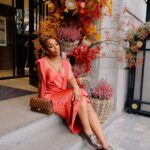 Jackie Aina Instagram - let me wear burnt orange ONE TIME 🤭 slip dress + cardigan: All Saints shoes + handbag: Chanel One Aldwych
