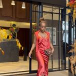 Jackie Aina Instagram - let me wear burnt orange ONE TIME 🤭 slip dress + cardigan: All Saints shoes + handbag: Chanel One Aldwych