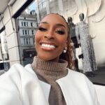 Jackie Aina Instagram - where we going? 💭 🗺️ (swipe to the end to find out) coat: #dior cardigan: #dissh shorts: #jacquemus boots: Dior handbag: #bottega earrings: Dior #londonstreetstyle #londonfashion Hermes New Bond Street