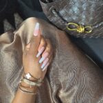 Jackie Aina Instagram - a series of fortunate events 🤗 cardigan + dress Dissh shoes: Gucci handbag: Bottega The Landmark London