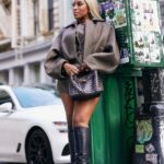 Jackie Aina Instagram - I’m not like other girls, I’m way worse 😘 coat + shorts @jacquemus via @farfetch boots @ralphlauren bag #bottegaveneta photos @nishajohny hair @kendrasboutique
