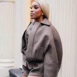 Jackie Aina Instagram - I’m not like other girls, I’m way worse 😘 coat + shorts @jacquemus via @farfetch boots @ralphlauren bag #bottegaveneta photos @nishajohny hair @kendrasboutique