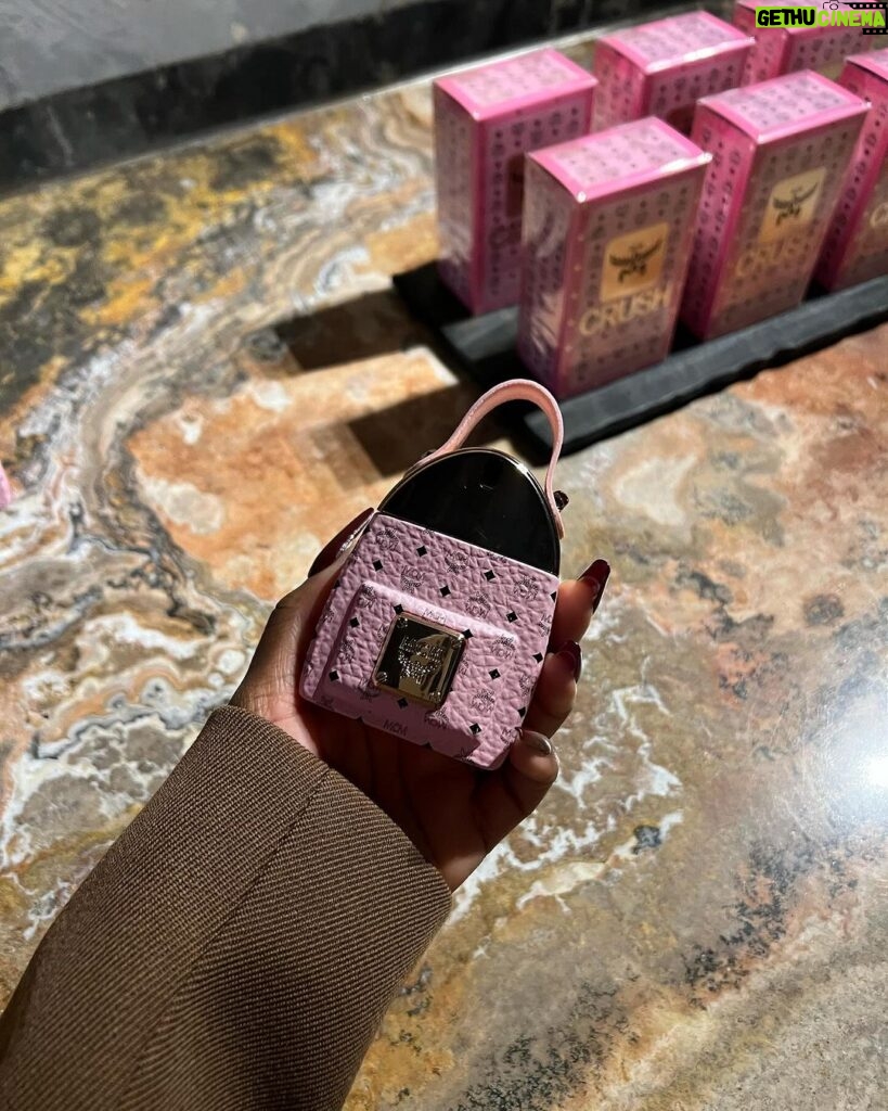 Jackie Aina Instagram - Essential accessories at @mcmworldwide Can confirm the new Crush fragrance smells GORG! #milanfashionweek #mcmworldwide #mcm #mcmfragrance