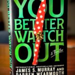 James Murray Instagram – Here it is! The cover for our brand new, terrifying serial killer novel YOU BETTER WATCH OUT, coming out on October 15th! 

Pre-order a copy today here (or anywhere books are sold): www.YouBetterWatchOutNovel.com

Then, email your proof of purchase to YouBetterWatchOutNovel@gmail.com and I’ll send you a weekly video from now until the book launches showing you the entire, incredible process!

YOU BETTER WATCH OUT SYNOPSIS:
From international bestselling authors James S. Murray (better known as “Murr” on the hit TV show Impractical Jokers) and Darren Wearmouth, comes You Better Watch Out, a suspenseful, serial killer thriller that leaves you wondering, is Christmas really the best time of the year?  Forty-eight hours until Christmas, Jessica Kane wakes up with blurred vision, ears ringing, and in excruciating pain. A gash in her head and blood running down her face, the last thing she remembers is going for a run and something or someone hitting her in the head.  It doesn’t take her long to realize she is trapped in an unknown, deserted town with five other strangers who share similar stories of being attacked and stranded there. Unsure why and how they got there, she knows one thing for certain, she has to find a way out.  That becomes nearly impossible when someone is meticulously orchestrating their deaths, one by one, and the only thing Jessica can do is watch the life leave their eyes.   The fenced-in town is the killer’s very own playground and there’s nowhere left to hide… she better watch out because she could be next.