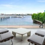 Jason Oppenheim Instagram - Just Sold - 2201 Bayside Dr. - $24,500,000 5 Beds / 9 Baths / 9,129 Sq. Ft. This newly constructed custom estate offers exclusive Corona Del Mar waterfront living with intricate design touches and a harmonious blend of natural stone and wood elements. Consisting of 5 ensuite bedrooms and 9 bathrooms and approximately 50 feet of private beachfront, it caters to water enthusiasts and offers shared ownership of one of the longest private docks on the west coast, capable of accommodating multiple yachts up to 100ft in length. Upon arrival, you will be greeted by meticulously landscaped surroundings, a grand pivot door, and a double height foyer that sets the tone for the residence. Inside, the space boasts European wide plank bleached oak flooring by Gaetano, illuminated floating staircases, and expansive glass features that fill the approximately 9,129 square feet of interiors with an abundance of natural light. The property seamlessly connects to its surroundings through slide-away pocket doors that open onto a heated patio, a zero-edge saltwater pool and spa, and a courtyard featuring a built-in Lynx Grill. The kitchen features custom Honed Calcatta Vagli slab countertops and backsplash, a 55” La Canche designer stove imported from Paris, a butler’s pantry, and stained white oak cabinetry. Convenience is paramount, with a Waupaca elevator servicing all four floors, including the lower level, which encompasses a media area, a dry bar, and temperature controlled wine room. Upstairs, the owner’s suite presents a heated wraparound balcony with mesmerizing water views, a living space with a fireplace, and two spa-like bathrooms, each complemented by its own walk-in closet. The top level reveals a lounge area that opens onto a rooftop deck with grass and sweeping views of the Newport Beach Harbor offering limitless ocean-view entertaining. Equipped with cutting-edge technology, the property also includes a nearly 3,000 sq. ft., 6+ car garage with epoxy flooring. Expertly designed by Brandon Architects, Patterson Custom Homes, Harvard Investment Group, and Brooke Wagner Design. Listed by: @mskaylacardona @briancharlesfurstenfeld Matthew Peters @jasonoppenheim