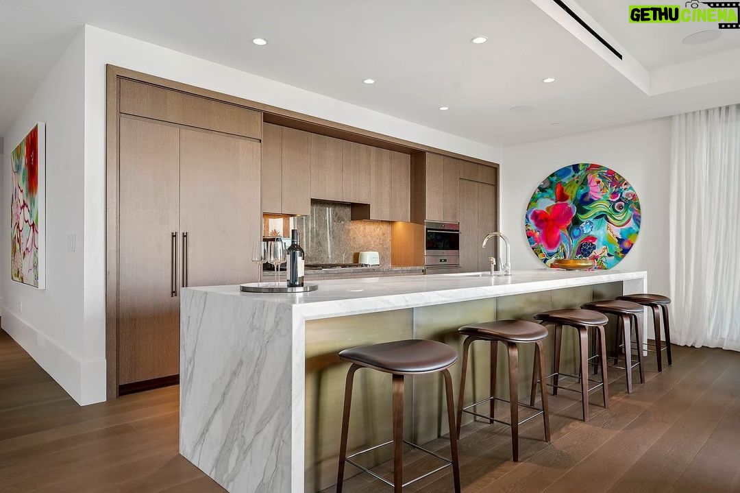 Jason Oppenheim Instagram - Just Listed - The Pendry Residences #307 - $4,195,000 2 Beds / 3 Baths / 2,393 Sq. Ft. Immerse yourself in luxury at the Pendry Residences, a 24-hour full-service amenity building, located on the iconic Sunset Strip in West Hollywood. Residence 307 offers unparalleled privacy with breathtaking south-facing Downtown LA views. Serene and sophisticated, the home exudes an opulent ambiance with wide plank white oak flooring and floor-to-ceiling glass walls that bathe the space in natural light. The chef's kitchen, designed by Martin Brudnizki, is the perfect blend of functionality and elegance equipped with top-of-the-line Subzero and Wolf appliances, custom white oak stained cabinetry, Waterworks fixtures, and an oversized Calacata Borghini marble island. The generously sized primary suite is a haven of luxury, featuring a customized Poliform walk-in closet and a marble spa-like bathroom with custom double vanities and high-end polished chrome fixtures. Completing the residence are a guest bedroom with en-suite bath, powder room, laundry room, in-wall speakers, direct access via a private elevator, and two side-by-side parking spaces equipped with a triple charger. The Pendry Residences offers a range of residential amenities, including 24-hour concierge and security services, valet parking, a state-of-the-art fitness center, a resident lounge, a tranquil garden deck, a rooftop pool, and services of the Pendry Hotel. West Hollywood, California