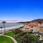 Jason Oppenheim Instagram - Just Listed - 22 Ritz Cove - $15,900,000 5 Beds / 5 Baths / 5,502 Sq. Ft. / 9,660 Lot Size Welcome to this exquisite oceanfront residence situated in the guard-gated community of Ritz Cove, one of the most sought-after coastal communities in Orange County where unrivaled luxury and exclusivity converge. Nestled between the iconic Ritz Carlton luxury hotel and the Monarch Beach Golf Course, this one-of-a-kind beachfront property offers breathtaking year-round views of sunsets over the break at Salt Creek Beach and Catalina Island from nearly every room in the home. Upon entering, you are enveloped by the welcoming, bright and airy floor plan and feel instantly at peace in your own private oasis. Five bedrooms and five bathrooms are spread across two levels, and a bonus room provides the flexibility to create a home office, media room, or gym. The large curved glass window in the kitchen invites the ocean inside, while the attached living room space creates an entertaining paradise that opens up onto the private patio with spa, setting the perfect stage for outdoor gatherings and sophisticated entertaining. The master suite is a true sanctuary, featuring an expansive bedroom and private balcony with sweeping views of the Pacific Ocean and the Ritz Carlton. The master bath boasts a lavish soaking tub for two, a separate shower, and exquisite dual vanities, all under a skylight that bathes the room in a glowing light. The suite extends into an extensive private master closet space apportioned with all the necessary amenities, including a 3-way mirror and attached locking closet. Additionally, a private stairway with a private gated entrance grants direct access to the pristine beach and countless walking trails directly from the backyard. This breathtaking beachfront property presents an unparalleled opportunity for a personal haven of relaxation and entertaining while offering the most captivating ocean and white-water views. Co-listed with @katinreinhardt Dana Point