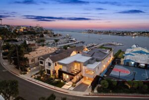 Jason Oppenheim Instagram - Just Listed - 2201 Bayside Dr. - $27,995,000

5 Beds / 9 Baths / 9,129 Sq. Ft. / 11,921 Lot Size

This newly constructed custom estate offers exclusive Corona Del Mar waterfront living with intricate design touches and a harmonious blend of natural stone and wood elements. Consisting of 5 ensuite bedrooms and 9 bathrooms and boasting approximately 50 feet of private beachfront, it caters to water enthusiasts and offers shared ownership of one of the longest private docks on the west coast, capable of accommodating multiple yachts up to 100ft in length. Upon arrival, you will be greeted by meticulously landscaped surroundings, a striking grand pivot door, and a double height foyer that sets the tone for the residence. Inside, the space boasts European wide plank bleached oak flooring by Gaetano, illuminated floating staircases, and expansive glass features that fill the approximately 9,129 square feet of interiors with an abundance of natural light. The property seamlessly connects to its surroundings through slide-away pocket doors that open onto a heated patio, a zero-edge saltwater pool and spa, and a courtyard featuring a built-in Lynx Grill. The kitchen features custom Honed Calcatta Vagli slab countertops and backsplash, a 55" La Canche designer stove imported from Paris, a butler's pantry, and stained white oak cabinetry. Convenience is paramount, with a Waupaca elevator servicing all four floors, including the lower level, which encompasses a media area, a dry bar, and temperature controlled wine room. Upstairs, the owner's suite presents a heated wraparound balcony with mesmerizing water views, a living space with a fireplace, and two spa-like bathrooms, each complemented by its own walk-in closet. The top level reveals a lounge area that opens onto a rooftop deck with grass and sweeping views of the Newport Beach Harbor offering limitless ocean-view entertaining. Equipped with cutting-edge technology, the property also includes a nearly 3,000 sq. ft., 6+ car garage with epoxy flooring.

Listed by 
@briancharlesfurstenfeld
@mskaylacardona
@jasonoppenheim