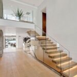 Jason Oppenheim Instagram - Just Listed - 2201 Bayside Dr. - $27,995,000 5 Beds / 9 Baths / 9,129 Sq. Ft. / 11,921 Lot Size This newly constructed custom estate offers exclusive Corona Del Mar waterfront living with intricate design touches and a harmonious blend of natural stone and wood elements. Consisting of 5 ensuite bedrooms and 9 bathrooms and boasting approximately 50 feet of private beachfront, it caters to water enthusiasts and offers shared ownership of one of the longest private docks on the west coast, capable of accommodating multiple yachts up to 100ft in length. Upon arrival, you will be greeted by meticulously landscaped surroundings, a striking grand pivot door, and a double height foyer that sets the tone for the residence. Inside, the space boasts European wide plank bleached oak flooring by Gaetano, illuminated floating staircases, and expansive glass features that fill the approximately 9,129 square feet of interiors with an abundance of natural light. The property seamlessly connects to its surroundings through slide-away pocket doors that open onto a heated patio, a zero-edge saltwater pool and spa, and a courtyard featuring a built-in Lynx Grill. The kitchen features custom Honed Calcatta Vagli slab countertops and backsplash, a 55" La Canche designer stove imported from Paris, a butler's pantry, and stained white oak cabinetry. Convenience is paramount, with a Waupaca elevator servicing all four floors, including the lower level, which encompasses a media area, a dry bar, and temperature controlled wine room. Upstairs, the owner's suite presents a heated wraparound balcony with mesmerizing water views, a living space with a fireplace, and two spa-like bathrooms, each complemented by its own walk-in closet. The top level reveals a lounge area that opens onto a rooftop deck with grass and sweeping views of the Newport Beach Harbor offering limitless ocean-view entertaining. Equipped with cutting-edge technology, the property also includes a nearly 3,000 sq. ft., 6+ car garage with epoxy flooring. Listed by @briancharlesfurstenfeld @mskaylacardona @jasonoppenheim Corona del Mar