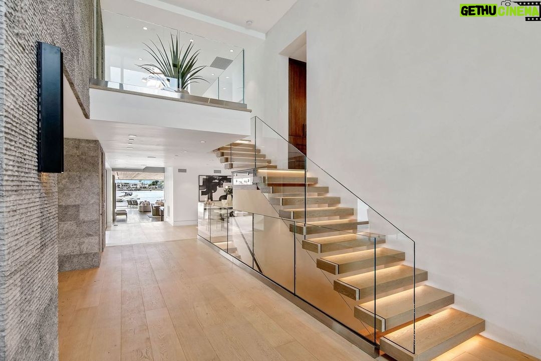 Jason Oppenheim - 53.2K Likes - Just Listed - 2201 Bayside Dr. - $27,995,000
5 Beds / 9 Baths / 9,129 Sq. Ft. / 11,921 Lot Size
This newly constructed custom estate offers exclusive Corona Del Mar waterfront living with intricate design touches and a harmonious blend of natural stone and wood elements. Consisting of 5 ensuite bedrooms and 9 bathrooms and boasting approximately 50 feet of private beachfront, it caters to water enthusiasts and offers shared ownership of one of the longest private docks on the west coast, capable of accommodating multiple yachts up to 100ft in length. Upon arrival, you will be greeted by meticulously landscaped surroundings, a striking grand pivot door, and a double height foyer that sets the tone for the residence. Inside, the space boasts European wide plank bleached oak flooring by Gaetano, illuminated floating staircases, and expansive glass features that fill the approximately 9,129 square feet of interiors with an abundance of natural light. The property seamlessly connects to its surroundings through slide-away pocket doors that open onto a heated patio, a zero-edge saltwater pool and spa, and a courtyard featuring a built-in Lynx Grill. The kitchen features custom Honed Calcatta Vagli slab countertops and backsplash, a 55" La Canche designer stove imported from Paris, a butler's pantry, and stained white oak cabinetry. Convenience is paramount, with a Waupaca elevator servicing all four floors, including the lower level, which encompasses a media area, a dry bar, and temperature controlled wine room. Upstairs, the owner's suite presents a heated wraparound balcony with mesmerizing water views, a living space with a fireplace, and two spa-like bathrooms, each complemented by its own walk-in closet. The top level reveals a lounge area that opens onto a rooftop deck with grass and sweeping views of the Newport Beach Harbor offering limitless ocean-view entertaining. Equipped with cutting-edge technology, the property also includes a nearly 3,000 sq. ft., 6+ car garage with epoxy flooring.
Listed by
@briancharlesfurstenfeld
@mskaylacardona
@jasonoppenheim