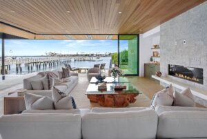 Jason Oppenheim Instagram - Just Listed - 2201 Bayside Dr. - $27,995,000

5 Beds / 9 Baths / 9,129 Sq. Ft. / 11,921 Lot Size

This newly constructed custom estate offers exclusive Corona Del Mar waterfront living with intricate design touches and a harmonious blend of natural stone and wood elements. Consisting of 5 ensuite bedrooms and 9 bathrooms and boasting approximately 50 feet of private beachfront, it caters to water enthusiasts and offers shared ownership of one of the longest private docks on the west coast, capable of accommodating multiple yachts up to 100ft in length. Upon arrival, you will be greeted by meticulously landscaped surroundings, a striking grand pivot door, and a double height foyer that sets the tone for the residence. Inside, the space boasts European wide plank bleached oak flooring by Gaetano, illuminated floating staircases, and expansive glass features that fill the approximately 9,129 square feet of interiors with an abundance of natural light. The property seamlessly connects to its surroundings through slide-away pocket doors that open onto a heated patio, a zero-edge saltwater pool and spa, and a courtyard featuring a built-in Lynx Grill. The kitchen features custom Honed Calcatta Vagli slab countertops and backsplash, a 55" La Canche designer stove imported from Paris, a butler's pantry, and stained white oak cabinetry. Convenience is paramount, with a Waupaca elevator servicing all four floors, including the lower level, which encompasses a media area, a dry bar, and temperature controlled wine room. Upstairs, the owner's suite presents a heated wraparound balcony with mesmerizing water views, a living space with a fireplace, and two spa-like bathrooms, each complemented by its own walk-in closet. The top level reveals a lounge area that opens onto a rooftop deck with grass and sweeping views of the Newport Beach Harbor offering limitless ocean-view entertaining. Equipped with cutting-edge technology, the property also includes a nearly 3,000 sq. ft., 6+ car garage with epoxy flooring.

Listed by 
@briancharlesfurstenfeld
@mskaylacardona
@jasonoppenheim