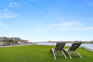Jason Oppenheim Instagram - Just Listed - 2201 Bayside Dr. - $27,995,000

5 Beds / 9 Baths / 9,129 Sq. Ft. / 11,921 Lot Size

This newly constructed custom estate offers exclusive Corona Del Mar waterfront living with intricate design touches and a harmonious blend of natural stone and wood elements. Consisting of 5 ensuite bedrooms and 9 bathrooms and boasting approximately 50 feet of private beachfront, it caters to water enthusiasts and offers shared ownership of one of the longest private docks on the west coast, capable of accommodating multiple yachts up to 100ft in length. Upon arrival, you will be greeted by meticulously landscaped surroundings, a striking grand pivot door, and a double height foyer that sets the tone for the residence. Inside, the space boasts European wide plank bleached oak flooring by Gaetano, illuminated floating staircases, and expansive glass features that fill the approximately 9,129 square feet of interiors with an abundance of natural light. The property seamlessly connects to its surroundings through slide-away pocket doors that open onto a heated patio, a zero-edge saltwater pool and spa, and a courtyard featuring a built-in Lynx Grill. The kitchen features custom Honed Calcatta Vagli slab countertops and backsplash, a 55" La Canche designer stove imported from Paris, a butler's pantry, and stained white oak cabinetry. Convenience is paramount, with a Waupaca elevator servicing all four floors, including the lower level, which encompasses a media area, a dry bar, and temperature controlled wine room. Upstairs, the owner's suite presents a heated wraparound balcony with mesmerizing water views, a living space with a fireplace, and two spa-like bathrooms, each complemented by its own walk-in closet. The top level reveals a lounge area that opens onto a rooftop deck with grass and sweeping views of the Newport Beach Harbor offering limitless ocean-view entertaining. Equipped with cutting-edge technology, the property also includes a nearly 3,000 sq. ft., 6+ car garage with epoxy flooring.

Listed by 
@briancharlesfurstenfeld
@mskaylacardona
@jasonoppenheim