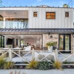 Jason Oppenheim Instagram - 🌴🤩 NEW LISTING 🤩🌴 1700 E Ocean Blvd 4 bed, 5 bath 3,520sqft Offered at: $8,950,000 Stunningly warm coastal farmhouse enveloped by iconic palm trees, situated on an oversized wide corner lot on the prestigious Peninsula Point. The 3-level home boasts pristine design and high-end finishes, including inviting white European oak floors outfitting the interiors, coupled with specialty tiles throughout the bathrooms. Custom White shiplap walls add another appealing component to each floor in the house. A chef’s kiss to the kitchen, it is topped with Calacatta marble and designer brass hardware with a large cascading waterfall island, large farmhouse sink, sleek white cabinets, and high-end appliances. The main level, with an open floor plan, comes replete with an airy and light-filled living area, a spacious dining area accentuated by a rustic white brick feature wall, cozy bar area, laundry room with double stacked appliances and powder bath. The custom pocket doors open the main level to the lower terrace boasting a fire pit, grill, and plenty of space for entertaining guests. The sleek primary suite includes large private balcony with breathtaking ocean view, spacious walk-in closet and a luxurious spa bathroom with dual vanities, a large soaking tub, oversized walk-in shower clad in marble, custom wood cabinetry with marble countertops, chic herringbone tile flooring, and mood lighting. The 3 spacious guest bedrooms luxuriate custom features throughout with one enjoying its own private balcony. The upper level has a custom-built minibar and a full bathroom complete with signature red-bricked walls. Behind folding glass doors, this level opens up to arguably the largest roof deck in the area. The magnificent 1,000+ sq. ft. rooftop terrace is truly an entertainer's dream with its multiple covered and uncovered lounging areas, fire pit, and a built-in grill and mini fridge, with stunning views overlooking the ocean, city and snowcapped mountains. A 3-car garage with Tesla/charging port, Sub-Zero fridge completes this rare offering, making it one of the best options out there for any discerning buyer. Listed with dream team: @jasonoppenheim & @justin_itzen