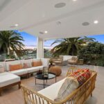Jason Oppenheim Instagram - 🌴🤩 NEW LISTING 🤩🌴 1700 E Ocean Blvd 4 bed, 5 bath 3,520sqft Offered at: $8,950,000 Stunningly warm coastal farmhouse enveloped by iconic palm trees, situated on an oversized wide corner lot on the prestigious Peninsula Point. The 3-level home boasts pristine design and high-end finishes, including inviting white European oak floors outfitting the interiors, coupled with specialty tiles throughout the bathrooms. Custom White shiplap walls add another appealing component to each floor in the house. A chef’s kiss to the kitchen, it is topped with Calacatta marble and designer brass hardware with a large cascading waterfall island, large farmhouse sink, sleek white cabinets, and high-end appliances. The main level, with an open floor plan, comes replete with an airy and light-filled living area, a spacious dining area accentuated by a rustic white brick feature wall, cozy bar area, laundry room with double stacked appliances and powder bath. The custom pocket doors open the main level to the lower terrace boasting a fire pit, grill, and plenty of space for entertaining guests. The sleek primary suite includes large private balcony with breathtaking ocean view, spacious walk-in closet and a luxurious spa bathroom with dual vanities, a large soaking tub, oversized walk-in shower clad in marble, custom wood cabinetry with marble countertops, chic herringbone tile flooring, and mood lighting. The 3 spacious guest bedrooms luxuriate custom features throughout with one enjoying its own private balcony. The upper level has a custom-built minibar and a full bathroom complete with signature red-bricked walls. Behind folding glass doors, this level opens up to arguably the largest roof deck in the area. The magnificent 1,000+ sq. ft. rooftop terrace is truly an entertainer's dream with its multiple covered and uncovered lounging areas, fire pit, and a built-in grill and mini fridge, with stunning views overlooking the ocean, city and snowcapped mountains. A 3-car garage with Tesla/charging port, Sub-Zero fridge completes this rare offering, making it one of the best options out there for any discerning buyer. Listed with dream team: @jasonoppenheim & @justin_itzen