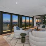 Jason Oppenheim Instagram - Just Listed - 8700 Franklin Ave. - $4,995,000 3 Bed / 3 Baths / 2,766 Sq. Ft. / 16,384 Lot Size Situated on its own promontory at the end of a quiet cul-de-sac street just above the Sunset Strip, this private mid-century home features unrivaled jetliner panoramic views of the entire city to the ocean. The swimmer's pool and outdoor patio evoke feelings of a five-star resort with an additional 20-foot waterfall, spa, and fire pit. Enter past the floor-to-ceiling front door to an open floor plan with a gorgeous living room, vaulted wood-beamed ceilings, a see-through fireplace, and a dining area with incredible views from every room. The sleek kitchen is complete with contemporary, top-of-the-line appliances. An additional bedroom, bathroom, and laundry room complete the main floor. A custom steel wall and floating staircase lead below to a large seating area and the luxurious owner's suite replete with a spa-like bathroom and walk-in closet, all opening to a massive deck. The third bedroom with an ensuite bath has floor-to-ceiling sliding doors perfect for an office or extra guest room. Detached 2-car garage and 2 uncovered parking spaces. The Sunset Strip