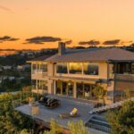 Jason Oppenheim Instagram - Just Listed - 8700 Franklin Ave. - $4,995,000 3 Bed / 3 Baths / 2,766 Sq. Ft. / 16,384 Lot Size Situated on its own promontory at the end of a quiet cul-de-sac street just above the Sunset Strip, this private mid-century home features unrivaled jetliner panoramic views of the entire city to the ocean. The swimmer's pool and outdoor patio evoke feelings of a five-star resort with an additional 20-foot waterfall, spa, and fire pit. Enter past the floor-to-ceiling front door to an open floor plan with a gorgeous living room, vaulted wood-beamed ceilings, a see-through fireplace, and a dining area with incredible views from every room. The sleek kitchen is complete with contemporary, top-of-the-line appliances. An additional bedroom, bathroom, and laundry room complete the main floor. A custom steel wall and floating staircase lead below to a large seating area and the luxurious owner's suite replete with a spa-like bathroom and walk-in closet, all opening to a massive deck. The third bedroom with an ensuite bath has floor-to-ceiling sliding doors perfect for an office or extra guest room. Detached 2-car garage and 2 uncovered parking spaces. The Sunset Strip