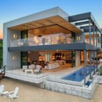 Jason Oppenheim Instagram – Just Listed – 2201 Bayside Dr. – $27,995,000

5 Beds / 9 Baths / 9,129 Sq. Ft. / 11,921 Lot Size

This newly constructed custom estate offers exclusive Corona Del Mar waterfront living with intricate design touches and a harmonious blend of natural stone and wood elements. Consisting of 5 ensuite bedrooms and 9 bathrooms and boasting approximately 50 feet of private beachfront, it caters to water enthusiasts and offers shared ownership of one of the longest private docks on the west coast, capable of accommodating multiple yachts up to 100ft in length. Upon arrival, you will be greeted by meticulously landscaped surroundings, a striking grand pivot door, and a double height foyer that sets the tone for the residence. Inside, the space boasts European wide plank bleached oak flooring by Gaetano, illuminated floating staircases, and expansive glass features that fill the approximately 9,129 square feet of interiors with an abundance of natural light. The property seamlessly connects to its surroundings through slide-away pocket doors that open onto a heated patio, a zero-edge saltwater pool and spa, and a courtyard featuring a built-in Lynx Grill. The kitchen features custom Honed Calcatta Vagli slab countertops and backsplash, a 55″ La Canche designer stove imported from Paris, a butler’s pantry, and stained white oak cabinetry. Convenience is paramount, with a Waupaca elevator servicing all four floors, including the lower level, which encompasses a media area, a dry bar, and temperature controlled wine room. Upstairs, the owner’s suite presents a heated wraparound balcony with mesmerizing water views, a living space with a fireplace, and two spa-like bathrooms, each complemented by its own walk-in closet. The top level reveals a lounge area that opens onto a rooftop deck with grass and sweeping views of the Newport Beach Harbor offering limitless ocean-view entertaining. Equipped with cutting-edge technology, the property also includes a nearly 3,000 sq. ft., 6+ car garage with epoxy flooring.

Listed by 
@briancharlesfurstenfeld
@mskaylacardona
@jasonoppenheim Corona del Mar