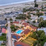 Jason Oppenheim Instagram – Record-Breaking Sale: The most expensive home to ever sell in Coronado – 1127 F Ave. – $28,000,000

5 Beds / 9 Baths / 14,054 Sq. Ft. / 25,265 Lot Size

This stunning Spanish estate sits on a palm-lined promenade just 100 feet from the beach, on one of the largest lots in Coronado. Originally built for business magnate W.A. Gunn, the four-bedroom (option for five), eight-bathroom abode features vintage Hollywood glamour adorned with state-of-the-art amenities for optimal luxury living space, replete with castle-like characteristics. Conceived by the illustrious Richard Requa in 1925, the previous owner preserved priceless historical heritage. Dominated by an impressive turret that acts as an entrance hall, the home’s exotic allure is undeniable, revealing a stunning foyer with a spiral staircase and striking, hand-hewn beams. Echoing the kind of extravagance that underscored the 1920s, “Coronado Castle” perfectly captures the era’s zeitgeist, rife with opulent tile flooring, ornate ironwork, and stained-glass touches. An immaculately hand-painted coffered ceiling dominates the formal dining room, punctuating the voluminous expanse that bleeds outward to the pool deck via a trio of custom steel glass doors. Grounded in reclaimed 18th-century European terracotta tile, Spanish embellishments abound. Preserving period details while meticulously updating the home to modern-day standards, historically accurate embellishments have been implemented throughout. Designed with a grand staircase and soaring ceilings, the voluminous basement boasts a golf simulator, media room with bar, trophy room, 25-seat movie theater with projector, 1,300+ sq. ft. world-class gym, and full spa with dry sauna, massage table, and ice bath. Inducing an air of timeless luxury, a stunning pool deck sets the stage for summertime soirees, complete with 250-year-old stonework, Moorish ironwork, a full outdoor kitchen, and dining estancia. The lush oasis includes 100-year-old rustic olive trees, three fountains, a putting green, a secret garden, and a dog run. Co-listed with @clementsgroupre Coronado Island, Coronado