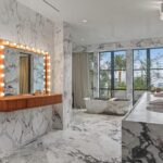 Jason Oppenheim Instagram - Just Listed - 1375 N. Doheny Dr. - $28,500,000 5 Beds / 9 Baths / 10,613 Sq. Ft. / 17,438 Lot Size Recently gracing the prestigious cover of Architectural Digest, this estate stands as an embodiment of timeless sophistication, meticulously curated from materials all over the world to create one of the most special homes in all of Los Angeles. Discreetly concealed beyond a privately gated driveway, an oversized motor court is laid with 200+ year-old reclaimed cobblestone from the historic streets of Boston. Experience the epitome of refined living with an open floor plan, double-height ceilings, and palatial steel-framed Crittal sliding glass doors which seamlessly unite the interior/outdoor spaces including a serene pool, covered patio, and verdant lawn. The sensuous chef’s kitchen is an epicurean haven boasting custom bronze-patinated cabinets, top-of-the-line appliances including floating burners by Pitt, and 20 slabs of book-matched Calacatta marble bearing an Rorschach-like allure. The owner’s suite bath, inspired by Jean Michel Frank - a French art deco architect known for his soft, undulating lines - stands as the quintessence of unparalleled elegance and decadence; every square inch has been cocooned in 40 slabs of Calacatta Breccia Capraia, (an impossibly rare marble from Italy that was used throughout Italian churches for hundreds of years) including the steam shower’s built-in chaise lounge to the monolithic tub hewn from a single block of stone, all paired with opulent Waterworks fixtures. Bespoke amenities include an office wrapped in an envelope of reclaimed French Oak, a state-of-the-art theater, wine cellar, gym, recreation room, private library, unrivaled security, and audio/visual integration. Unquestionably the most impressively crafted and composed property available, tailored for the most discerning buyer desiring perfection. Listed by @themarybonnet @jasonoppenheim