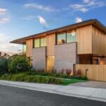 Jason Oppenheim Instagram - Just Listed in Manhattan Beach - 1001 1st St. - $29,900,000 6 Beds / 9 Baths / 9,479 Sq. Ft. The most impressive and high-quality Contemporary estate ever built in Manhattan Beach, featuring panoramic ocean views from every room. After a laborious multi-year build, this approximately 9,500 sq. ft. showstopper seamlessly fuses glass, cedar, and concrete into a triumphant architectural tour de force with a sense of permanence and grandeur. Integral to the structure and aesthetic of the home, the scalloped concrete walls seen on the exterior and interior walls resemble an undulating wave-like texture accomplished by custom milled formwork which complement the surrounding Pacific landscape. Custom cedar clads the remaining walls and ceilings, bringing warmth and visual impact throughout the sleek space. Double-height ceilings and oversized automated Otiima pocketing doors and windows create a sense of expansion within, as the home seamlessly unfolds into an extensive beautifully landscaped outdoor terrace and pool/spa perfect for California living. An additional shaded patio with fireplace is created by the deep cedar overhangs from the upper floor and the roof. Generously nestled on an extra-wide corner lot, the home is replete with 6 bedrooms plus an additional office/nursery, 9 bathrooms, home theater, game room, wine cellar, wet bar, and gym, with architecture by Laney LA. Additional amenities include 48 solar panels with Tesla Powerwalls, elevator, 14 zone A/C technology platform system, Control4 home automation, and 3-car garage with additional driveway parking. An exceptionally rare opportunity to own a meticulously crafted beach estate with soul and sophistication. Manhattan Beach, California