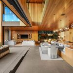 Jason Oppenheim Instagram - Just Listed in Manhattan Beach - 1001 1st St. - $29,900,000 6 Beds / 9 Baths / 9,479 Sq. Ft. The most impressive and high-quality Contemporary estate ever built in Manhattan Beach, featuring panoramic ocean views from every room. After a laborious multi-year build, this approximately 9,500 sq. ft. showstopper seamlessly fuses glass, cedar, and concrete into a triumphant architectural tour de force with a sense of permanence and grandeur. Integral to the structure and aesthetic of the home, the scalloped concrete walls seen on the exterior and interior walls resemble an undulating wave-like texture accomplished by custom milled formwork which complement the surrounding Pacific landscape. Custom cedar clads the remaining walls and ceilings, bringing warmth and visual impact throughout the sleek space. Double-height ceilings and oversized automated Otiima pocketing doors and windows create a sense of expansion within, as the home seamlessly unfolds into an extensive beautifully landscaped outdoor terrace and pool/spa perfect for California living. An additional shaded patio with fireplace is created by the deep cedar overhangs from the upper floor and the roof. Generously nestled on an extra-wide corner lot, the home is replete with 6 bedrooms plus an additional office/nursery, 9 bathrooms, home theater, game room, wine cellar, wet bar, and gym, with architecture by Laney LA. Additional amenities include 48 solar panels with Tesla Powerwalls, elevator, 14 zone A/C technology platform system, Control4 home automation, and 3-car garage with additional driveway parking. An exceptionally rare opportunity to own a meticulously crafted beach estate with soul and sophistication. Manhattan Beach, California