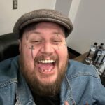 Jelly Roll Instagram - This tour started a few weeks ago and honestly I haven’t had much time to sit and collect my thoughts. So forgive me for this long post — I wanted to share this with you— When I was young there was an Amphitheater in Antioch called “Starwood”- I seen Lynyrd Skynyrd , Tool, Lollapalooza , Sheryl Crow, Weezer, the Eagles, R.E.M, No Doubt, 311 and MANY MORE at this amphitheater. We would go early and hang out in the parking lot with other fans while they grilled and pre gamed- we would slide down the mud on the hill of the Lawn when it would rain- we would party in the parking lot after the show while waiting for traffic to slow down. Some of my greatest childhood memories are on the lawn of that amphitheater. I would’ve never dreamed back then that I would one day be headlining these same amphitheaters around America . Every night I look out in the crowd and I remember music transforming my life in those same bleachers and lawns. This tour has been nothing short of UNREAL so far. I’m overwhelmed with gratitude and get emotional on stage almost every night. Looking at out at 10s of THOUSANDS of people singing along and living in the moment. I get off stage every night feeling hopeful like I just left a good Sunday service on a backroad in Tennessee. I hope y’all are feeling the same when you leave the show as well. Thank y’all for making this tour what it has been so far….I do not take this for granted for a single second. PS - I don’t take selfies unless it’s for my wife — this was me very high and happy about my new hat and I sent it to mama bear- thought it was funny enough to post lol