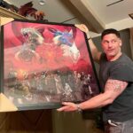 Joe Manganiello Instagram – Got the band back together after three years of remote play and no play… 
WAR OF DRAGONS Episode 73 kicked off with a food truck and a two hour recap from the very first adventure five years ago, all the way through to the present. 
The Sandal of Gygax made its appearance as it settled into its new home for the next calendar year at The E. Gary Gygax Memorial Dungeon in Beverly Park next to a set of Gary’s dice gifted to me by his son Luke for my 42nd birthday a few years back. 
Vince spearheaded a surprise for me, a framed piece of art by Max Dunbar that was used to craft the Wizkids miniatures sets, including all of the characters in the group but this time, with a looming Tiamat above. So f-ing cool…
It was a blast seeing everyone in person! Can’t wait for the next session.