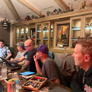 Joe Manganiello Instagram - Got the band back together after three years of remote play and no play… 
WAR OF DRAGONS Episode 73 kicked off with a food truck and a two hour recap from the very first adventure five years ago, all the way through to the present. 
The Sandal of Gygax made its appearance as it settled into its new home for the next calendar year at The E. Gary Gygax Memorial Dungeon in Beverly Park next to a set of Gary’s dice gifted to me by his son Luke for my 42nd birthday a few years back. 
Vince spearheaded a surprise for me, a framed piece of art by Max Dunbar that was used to craft the Wizkids miniatures sets, including all of the characters in the group but this time, with a looming Tiamat above. So f-ing cool…
It was a blast seeing everyone in person! Can’t wait for the next session.