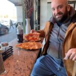 Joey Diaz Instagram - Lee enjoying a tremendous slice of pizza at Carlo’s….