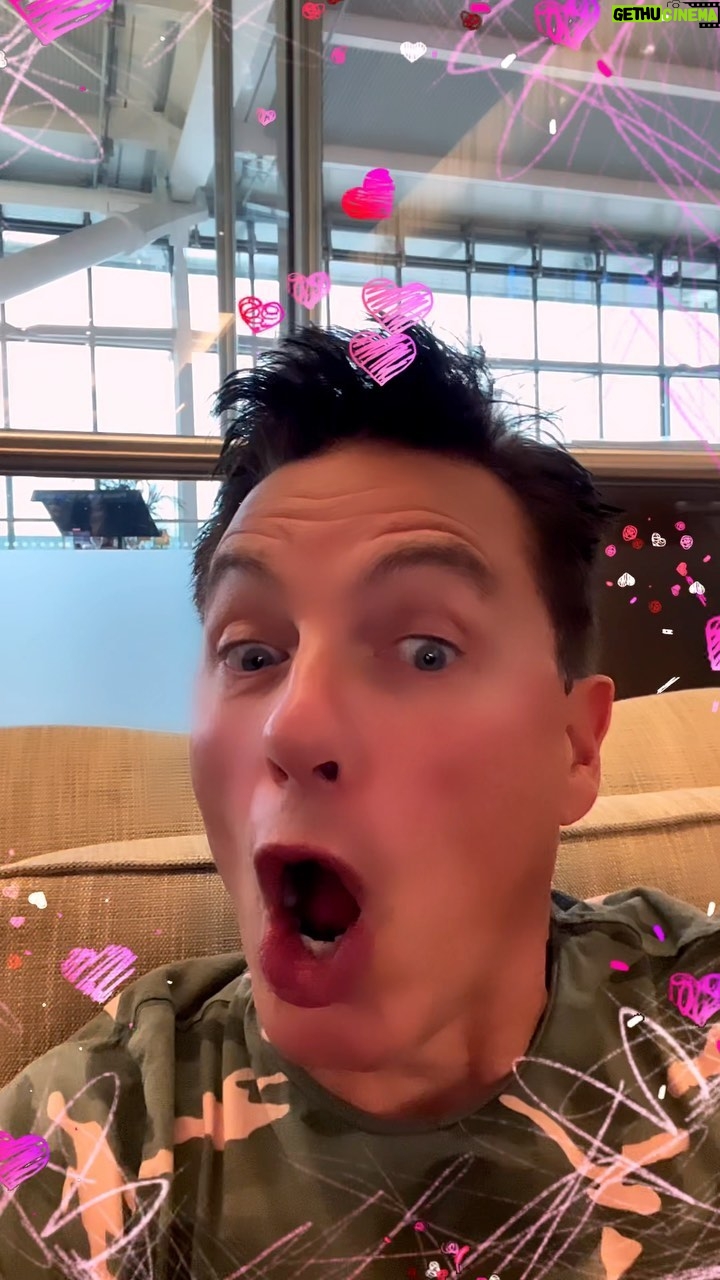 John Barrowman Instagram - I’m letting you in on a secret. Scott has no idea I’m surprising him with first class on @british_airways to Johannesburg. #Husband #lgbtq #johannesburg #london #travel #flights #airport #cocktails