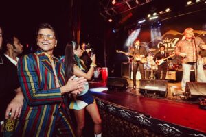 John Stamos Instagram - I thank my beautiful wife who knows how to throw a party - Fake Beatles, @raintribute (the best Beatles band ever!) Real Beach Boys, @mikeloveofficial @jamieleecurtis handing out @stamos bracelets, @glenpowell riding some big cow-like animal, all my friends, family, (party crashers) it was a 60’s party that was better than the actual 60’s ! 📸 @micalaaustin @canyonagoura THANK YOU!