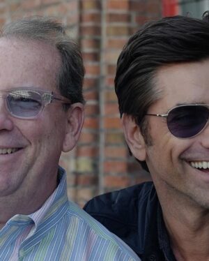 John Stamos Instagram - Today, I lost more than a friend; I lost a part of my soul, my history - Jeffrey Foskett, my dearest friend, brother, and the brightest light in my life, has left this world. 

This morning, when I got the news, uncontrollable tears streamed down my face, a physical manifestation of the heartache within. 

My son Billy heard my cries, joined my wife in holding me up, and then ran off, only to return with a small, tender offering – a drawing. His innocent hands sketched a picture of Jeff with hearts ascending to heaven, with me, waving goodbye. A stairway of hearts, and next to the top heart, he wrote God. A simple yet powerful symbol of love and loss that pierced through my grief.

Jeff was more than just a friend; he was the one who brought the harmonies of The Beach Boys into my life, and with them, a spectrum of color and joy I never dreamed would be part of my life. 

He was a vibrant force, a radiant soul whose laughter and wisdom touched everyone he met. He was an older brother in spirit, guiding, lifting, and loving me, sometimes more than I thought I deserved.

Jeff taught me that love is a beautiful and necessary part of our lives, but it comes with a cost—the unbearable pain of loss. It's the kind of pain that can make us question whether we should ever allow ourselves to love so deeply, so completely. Should we keep our walls up and shield our hearts from the world in an attempt to avoid the sharp, immense sorrow that follows when we say goodbye to someone we hold dear?

But then, as I reflect on Jeff's remarkable life and the profound impact he had on mine, I realize that this pain is the price we pay for the privilege of knowing and loving someone like him. Yes, the pain is excruciating and cuts deep into our souls, but it is a testament to the depth of our connection.

Yet, when I think of the 40 years we shared – the uproarious laughter, the music that we believed changed lives, and the unshakable bond of brotherhood – I can't help but feel grateful. Grateful for every moment, every note, every piece of wisdom he shared with me.  CONT.