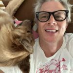 Johnny Knoxville Instagram - I can’t stop taking pictures of me and @bucket.biz. I’m a smidge under the weather so me and her have been curled up on the couch for a few days. I actually have a crick in the back of my neck because she sits on it like a cat. But she’s so cute I can’t tell her to get down. ❤️ Well that’s not entirely true as she has tooted on my shoulder a couple of times(see pic) and we do re-situate in those instances. 🙊