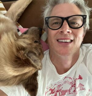 Johnny Knoxville Instagram - I can’t stop taking pictures of me and @bucket.biz. I’m a smidge under the weather so me and her have been curled up on the couch for a few days. I actually have a crick in the back of my neck because she sits on it like a cat. But she’s so cute I can’t tell her to get down. ❤️ Well that’s not entirely true as she has tooted on my shoulder a couple of times(see pic) and we do re-situate in those instances. 🙊