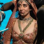 Jonita Gandhi Instagram - If I’m being honest, it was really hard to keep the inner goofball in check and channel pure bridal nazaakat that day 😅🌺♥️ Shoutout to my glam team for helping me keep it classy 🙊 Hair: @dwyessh_hairwizard @aaliyahussainhairmakeupcreator Makeup: @ankitamanwanimakeupandhair Styling: @gaurvivdesai @nupur_p Styling Asst : @Krishadedhia13 BTS photographer: @mnvlade Jonita’s Team: @akankshanamdeo @bysamrinsayed @njadoonanan Do you guys want to see more BTS clips and photos?