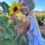 Julianne Hough Instagram - A few of my favorite things… sunflowers and a beautiful @victoriabeckham dress 🌻💜 Sunflowers are some of the most magical flowers I’ve come across, which is why they’re my favorite. They always turn to face the sun and they’re known as a symbol for hope, healing and joy - something I always strive to have in my life and surround myself with. Even named my little one Sunny ☀️🐶