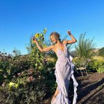 Julianne Hough Instagram - A few of my favorite things… sunflowers and a beautiful @victoriabeckham dress 🌻💜 Sunflowers are some of the most magical flowers I’ve come across, which is why they’re my favorite. They always turn to face the sun and they’re known as a symbol for hope, healing and joy - something I always strive to have in my life and surround myself with. Even named my little one Sunny ☀️🐶