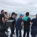 Justin Prentice Instagram - A year ago today, we started filming our short film Crossing Fences. Here we all are taking a break from shooting to watch the whales frolicking in the ocean. As you can see, I'm way more excited than anyone else. @annikapampel @ninarausch #filming #whales