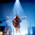 Kacey Musgraves Instagram - Starting this chapter in Nashville on @theryman’s hallowed ground is so meaningful to me. Last night’s “Deep Into The Well” album release show had me flooded with so much emotion I could barely sing at a certain point. Being that vulnerable in front of people isn’t super easy for me. Thank you for everyone who cried with me, helped make this record happen, and to those who are loving it. 🤍 Also. I partnered with @crcompact to ensure that for every single person that bought a ticket to the show a tree would be planted in Nashville. Thanks to you we’ll be planting 2,400 trees to give some roots back to the city as it continues to grow. Ryman Auditorium