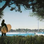 Karl Urban Instagram - Thrilled to be part of the @aventuurco team that are working to bring this amazing world class Surf park to Auckland New Zealand - the Wavegarden Cove proposed for Auckland has entered the final stage of consent. Designed with a strong focus on sustainability, the project will feature a 56-module Wavegarden integrated into the Dairy Flat landscape to embrace the area's rural aesthetic. It will showcase high-performance sports and leisure facilities, eco-cabins, lodging, a farm-to-table restaurant, public amenities, a solar farm, and a pioneering data center. In a world-first initiative, excess heat from the data center, which is powered by renewable energy, will be used to maintain the lagoon's water at the perfect temperature for optimal surfing conditions throughout the year.