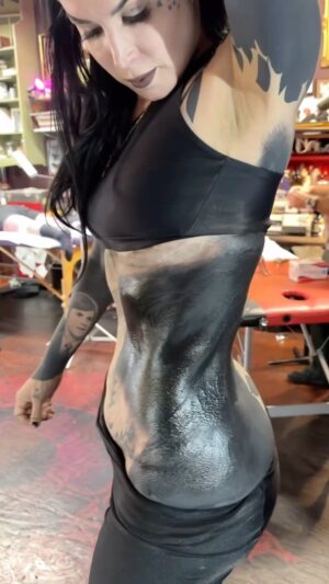 Kat Von D Instagram - 17 sessions, and almost 40 accumulative hours later, we are about 80% done with blacking out my body.  I’ve been consistently flying out to Philly to get tattooed by the amazing @hoode215 at his lovely tattoo shop @blackvulturegallery. 

Maybe before commenting any negativity, just remind yourself: What you consider ugly, might be beautiful to someone else.
 
•IF YOU DONT LIKE YOUR TATTOOS, WHY DON’T YOU GET THEM LASERED OFF? 

I actually did start lasering tattoos, and although I think laser tattoo removal is effective, I personally wasn’t a good candidate considering how much coverage I wanted to remove. 
Laser is a slow (and extremely painful) process, that depending on your tattoo, can take more than 10 sessions, including long healing periods in between. 

•ARE YOU GOING TO TATTOO WHITE OVER IT?

Nope. I love the simplicity of the black — but definitely have seen some beautiful ones where people tattoo white over their black out. 

•THAT CAN’T BE GOOD FOR YOUR HEALTH?

I’ve been getting tattooed for almost 3 decades, and have never felt a negative effect. 
Personally, I believe there’s more toxicity in most of the foods we eat, makeup we wear, and chemicals in cleaning supplies.  Are you eating 100% organic, eliminating all seed oils from your diet, cutting out all processed foods, sugars and food dyes?  Wearing perfumes or makeup without hormone disrupters, lighting candles without fragrance, cleaning without harsh chemicals? 
We can always try our best to pick our poisons. Personally I try my best to do all those things above, but I do love me some lipstick, candy and a tattoo every now and then!  And I’m ok with that. 😹

•WHY ARE YOU COVERING UP ALL YOUR TATTOOS?

I had many tattoos that represented a part of my life that no longer aligns with who I am today.  Some people are fine with keeping these types of landmarks in time on them — I personally grew tired of waking up to them, and seeing those constant reminders every time I looked in a mirror. 

Also, I really love the esthetic. I know it’s not for everyone but it is very satisfying to me to see a clean slate when I look down onto my arms. 

Lotsa Love! X
