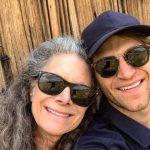 Keegan Allen Instagram - thinking of my mom on her birthday today. The beauty and grace she left remains along with her vacancy. It’s a soft pain I carry silently. But all is temporary except for love. You don’t need to read the rest, I’m just venting. It’s weird because it’s been a year, and I have only just begun to mourn. Sometimes it hits me all at once and sometimes it’s a light breeze. I’m still so disoriented in this version of outcome. I know there are so many people grieving different types of losses and grief and it’s complexities challenge us to go deeper into our own existence. Everything feels brutally incomplete without her. A deep friendship with my mother pulls me into heaven with her sometimes searching in dreams, listening to the wind, humming through the garden…unable to locate her I just accept reality. Everyone gives solace through quotes and guidances but it’s all a tool that doesn’t fit the job. My life with her was an epic journey, finished too soon. I live for her now but always reaching outside of the barriers. Today, maybe just for a moment, look around and try and find a place to exist and appreciate that existence. We are all having a human experience, and that’s it. It’s a fleeting thing and we only have the gift of now. I miss my mom, absolutely and forever. I know she’s standing on the moon or off on some cosmic adventure. Or, maybe she’s finally a little mushroom growing by the stream, her dream. Sweet dreams in a cabin by the fireplace. The scent of red cedar and roses.